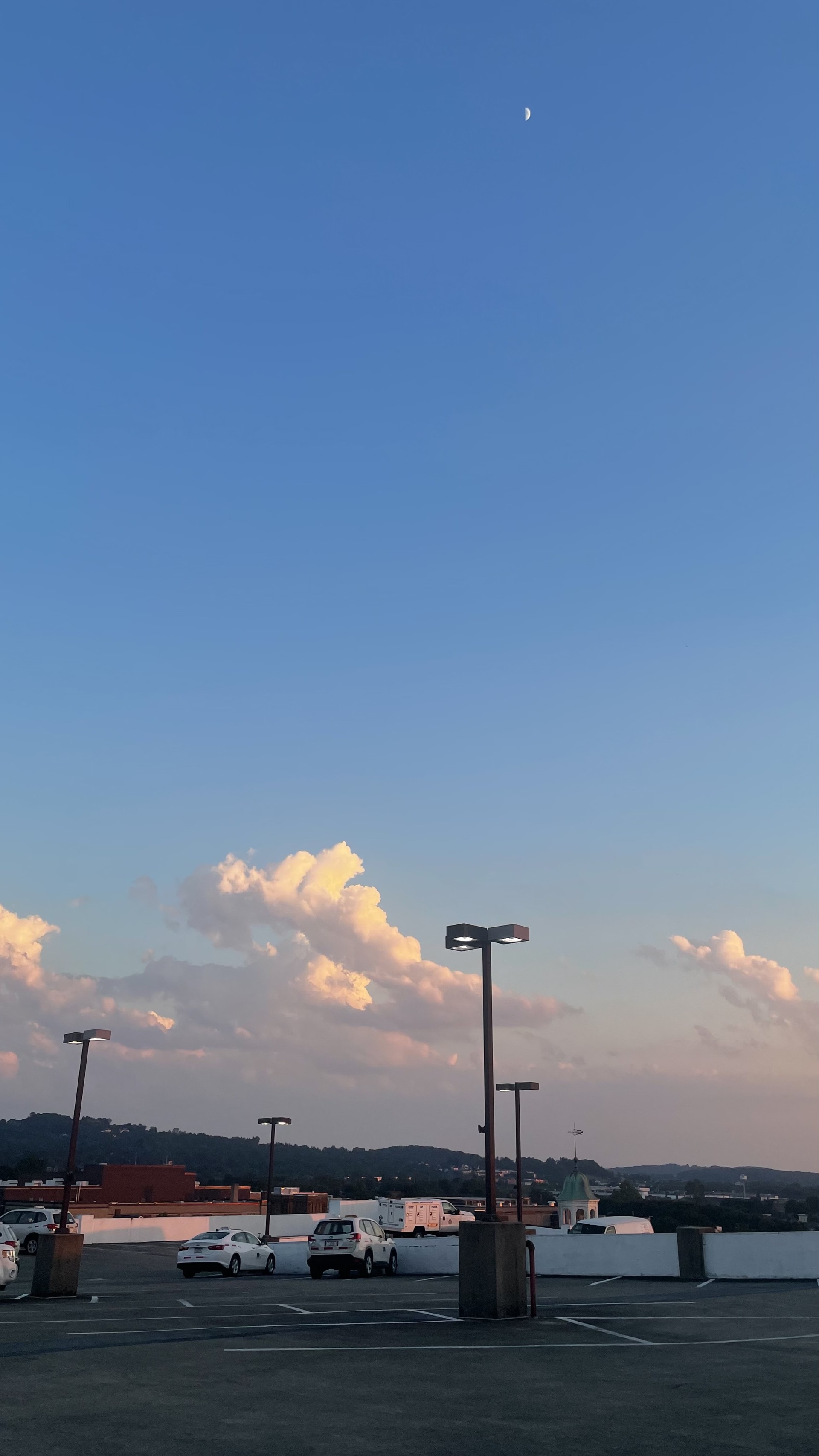  Rooftop Parking Lot at Sunset, overseeing the city